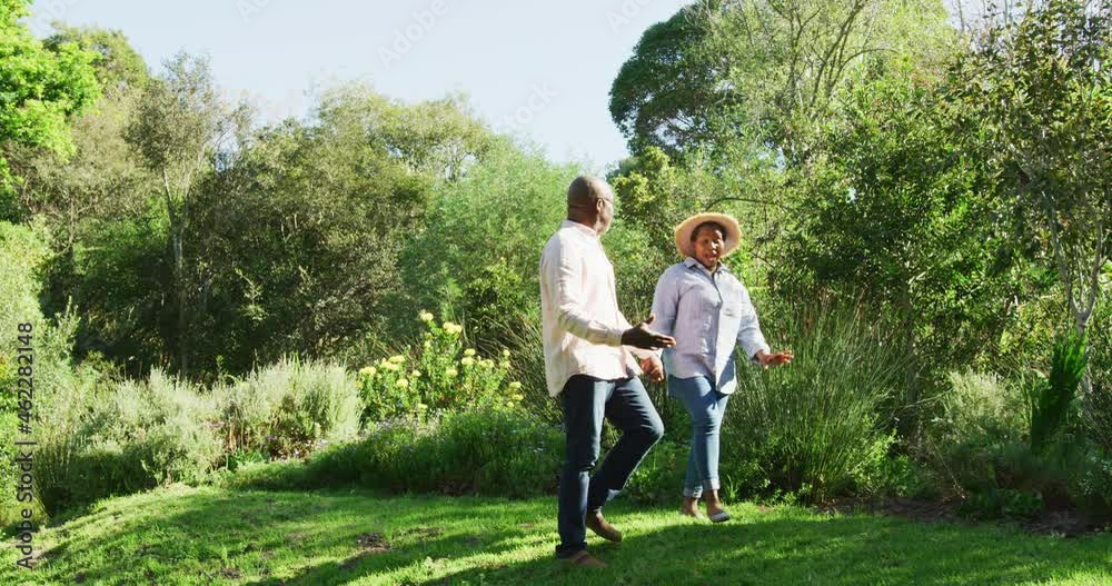 Happy african american senior couple walking outdoors