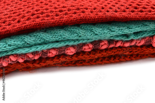 Knitted red, orange, green scarves.