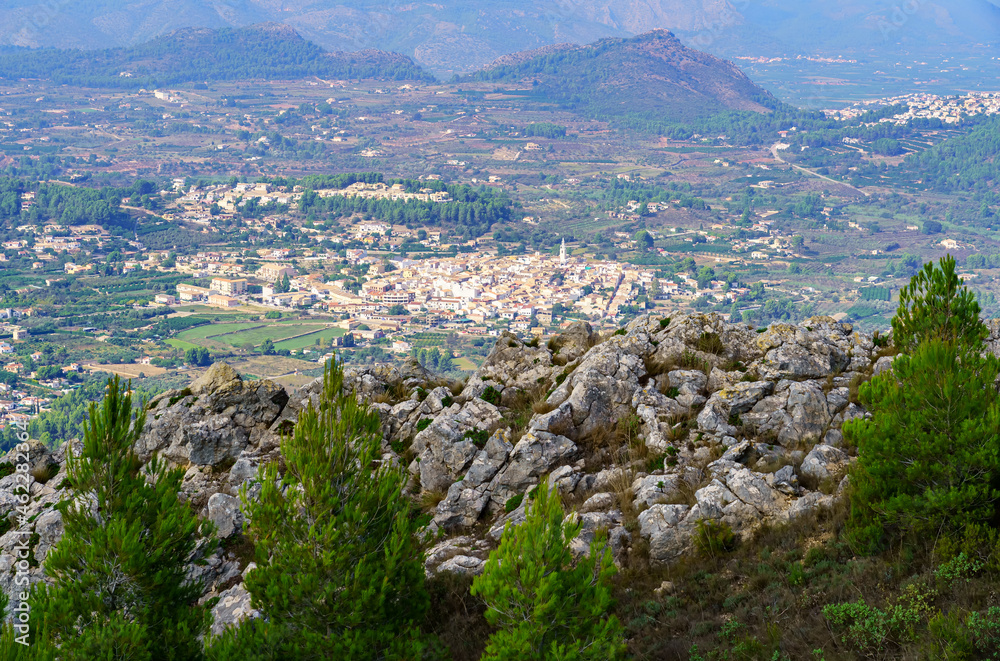 Aerial view of a town with white houses at the bottom of the valley. Aerial view of a town with white houses at the bottom of the valley.