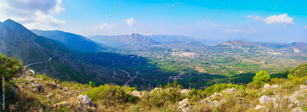Obraz premium Great panorama of the mountainous valley with small white villages in the distance. Alicante Spain.