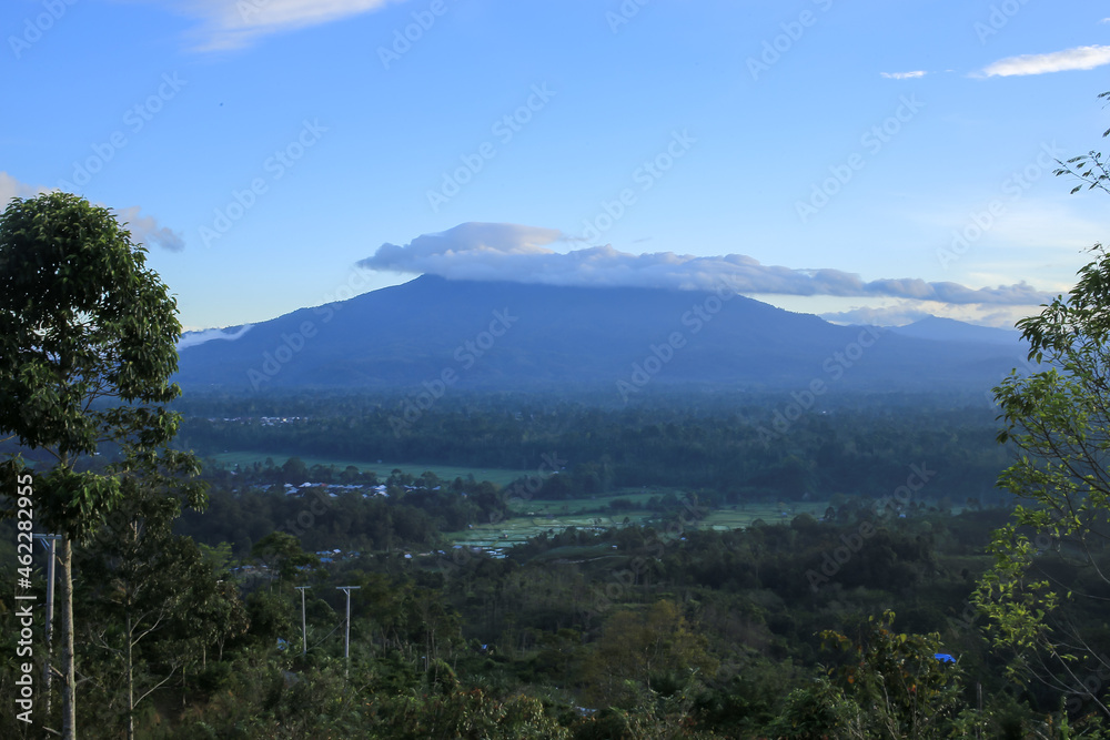 The view of the clouds above the mountain with the blue sky background creates a comfortable and cool atmosphere