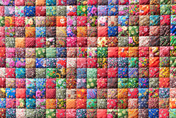 Traditional stylized handmade patchwork cover with bright colorful geometric flower patterns created for sale as vintage background