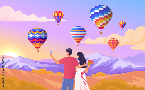 Young couple on a romantic date looking at the flight of balloons