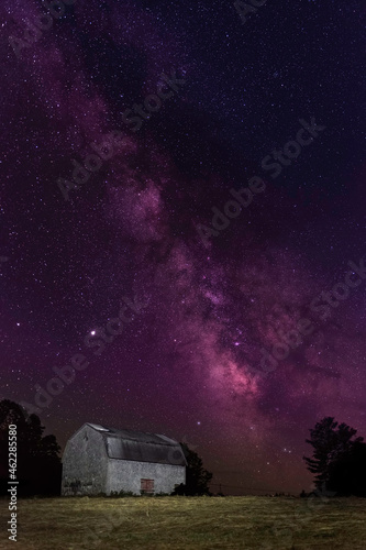 Vertical Panorama of an abandoned barn on the edge of a field, Conquerall Mills, Nova Scotia with the Milky Way galactic center rising behind. © Jason Bonfield