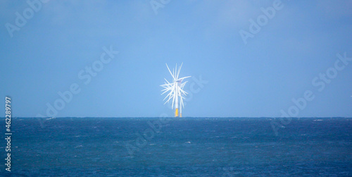 a head on view of several wind turbines in the action at Gwynt y Môr (Sea wind) 576-megawatt offshore electricity generating wind farm with 160 x 150m high turbines in Colwyn Bay Wales photo