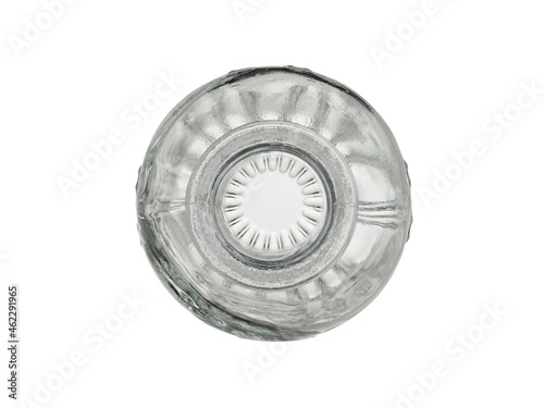 Empty, transparent glass bottle with a pattern. Isolated on a white background, close-up, top view
