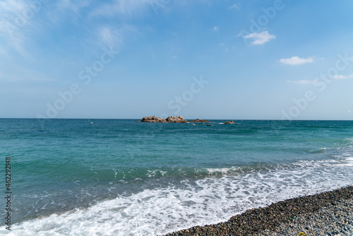 Rock reefs rising quietly on the sea and seabirds resting on them