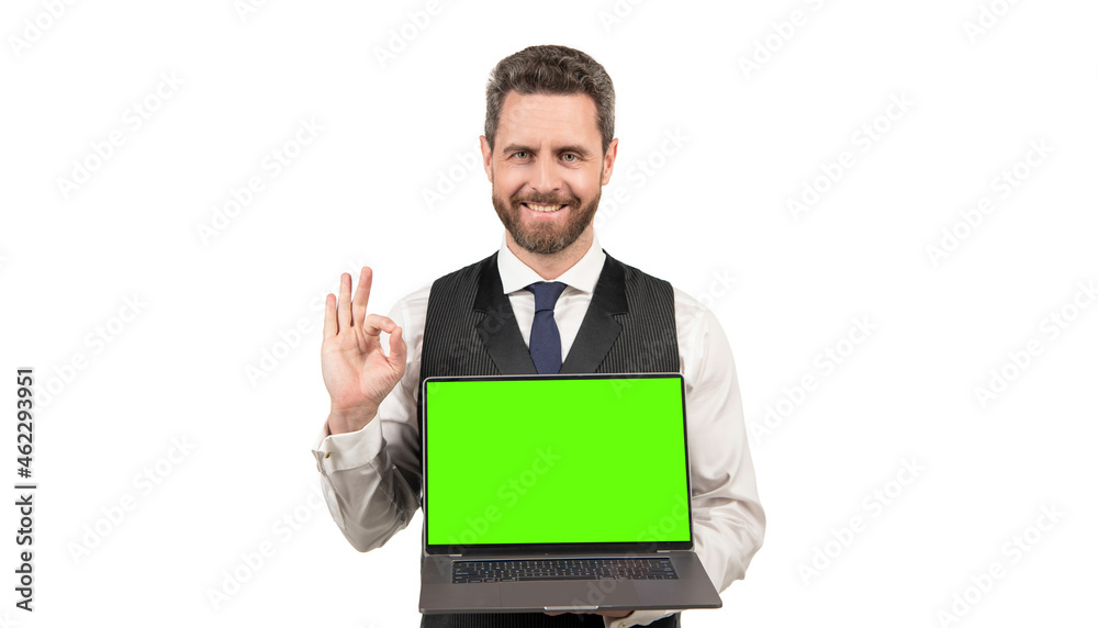 happy man presenting product of pc with green screen for copy space showing ok, presentation