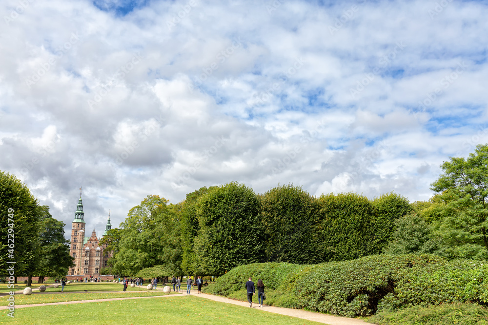 COPENHAGEN, DENMARK - AUGUST 29: Unidentified people walk in the gardens in the front of Rosenborg Castle in Copenhagen, Denmark on August 29, 2016.