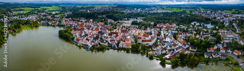 Aerial around the city Bad Waldsee in Germany on a cloudy afternoon in summer.
