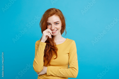 Fotótapéta Lifestyle concept - Close up Portrait young beautiful attractive ginger red hair girl playing with her hair with shyness