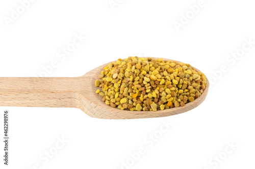 Bee pollen in wooden spoon isolated on white background. Natural herbal medicine