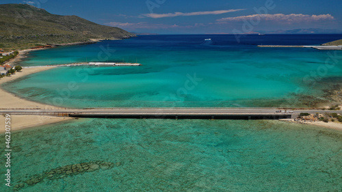 Aerial drone photo of tropical exotic paradise bay with deep turquoise sea and caves forming a blue lagoon visited by luxury yachts and sail boats