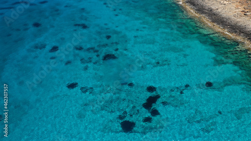 Aerial drone photo of tropical exotic paradise bay with deep turquoise sea and caves forming a blue lagoon visited by luxury yachts and sail boats © aerial-drone