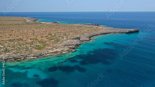 Aerial drone photo of tropical exotic paradise bay with deep turquoise sea and caves forming a blue lagoon visited by luxury yachts and sail boats