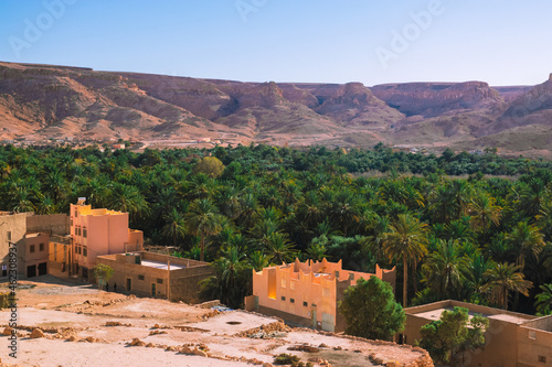 Africa Morocco desert Atlas mountains nature rock landscape with river palm under blue sky hot weather 