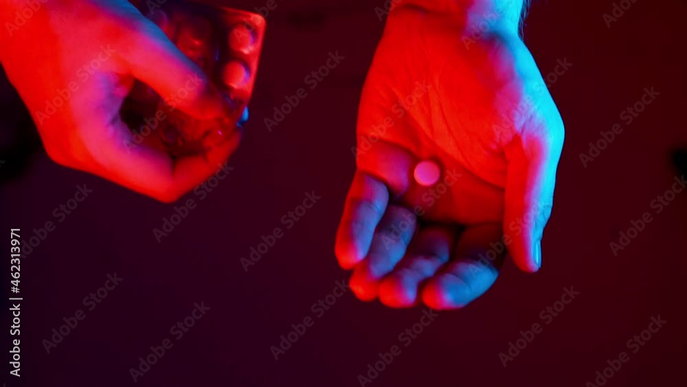 Man Pours A Pill From The Pills Pack In The Palm Of His Hand