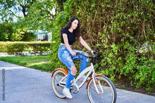 brunette girl riding a bike in the city