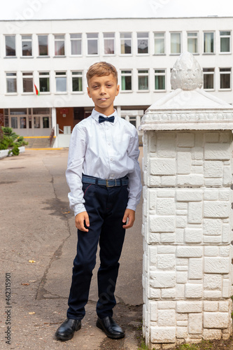 A beautiful eight-year-old boy in a school uniform