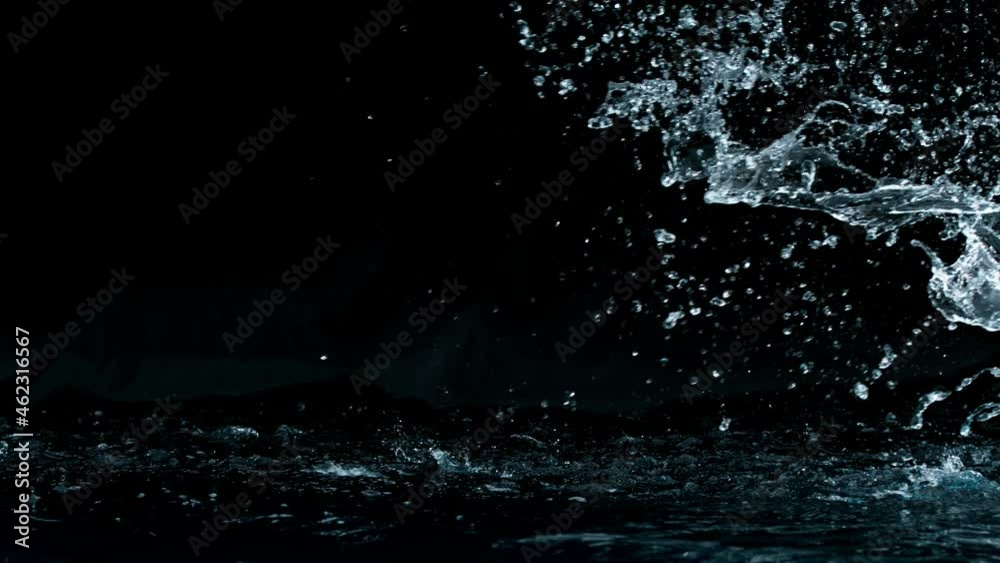 Super slow motion of big water splash on black background. Filmed on high speed cinema camera, 1000 fps.