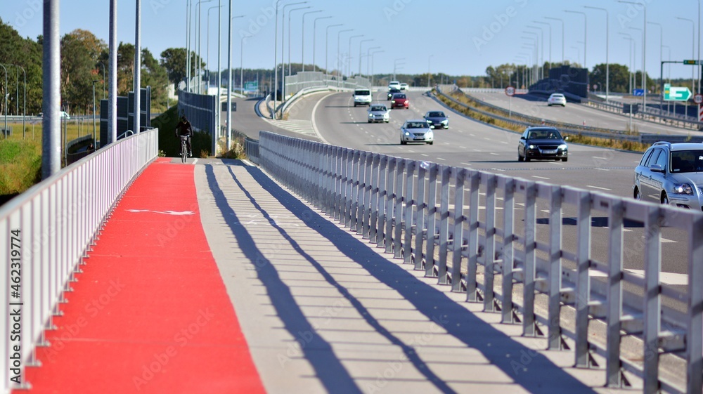 Bicycle path and sidewalk through the highway bridge.