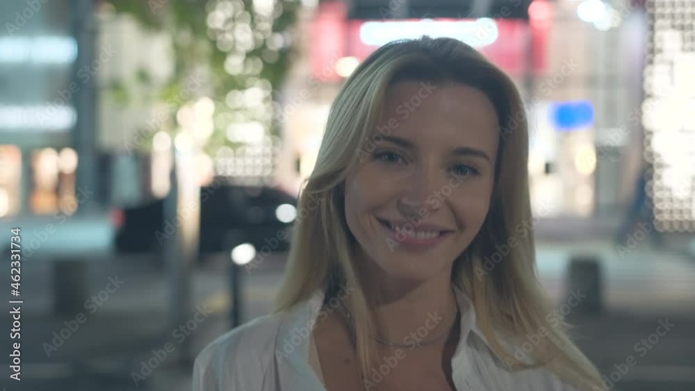 The beautiful woman walking at the night street. slow motion The beautiful woman walking at the night street. slow motion