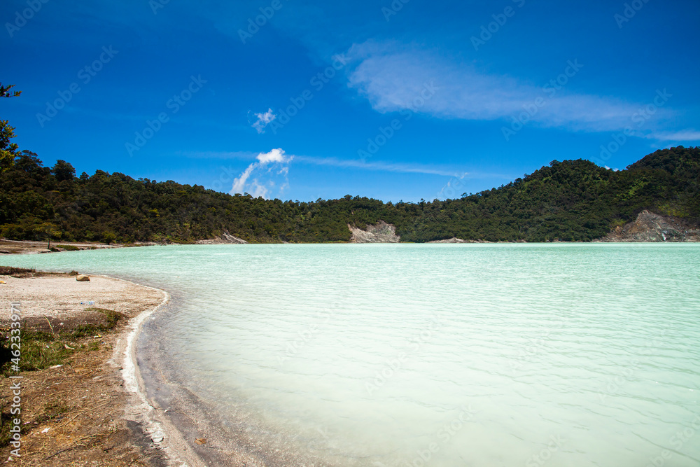 Naklejka premium Stunning view of the Talaga Bodas Lake surrounded by a green tropical forest. Talaga Bodas crater is one of popular tourist attractions in the Garut Regency in Java, Indonesia.