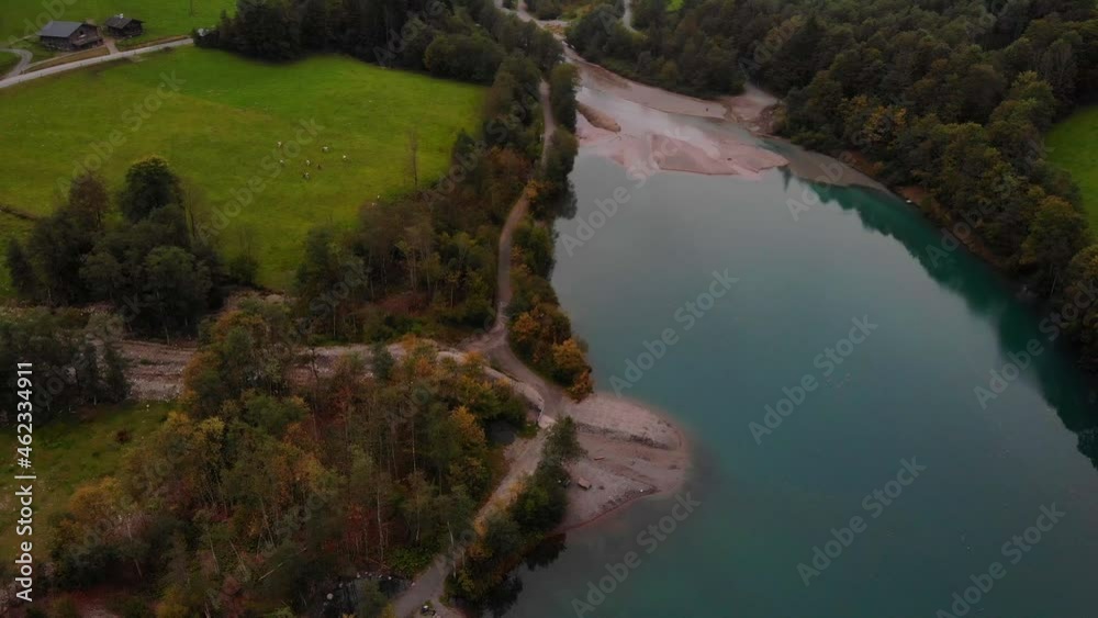 Green Meadows At The Shore Of The Famous Lake Of Klammsee On A Cloudy Day In Kaprun, Austria. aerial Green Meadows At The Shore Of The Famous Lake Of Klammsee On A Cloudy Day In Kaprun, Austria. aerial
