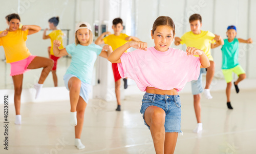 Young girls and boys performing hip-hop dance in studio.