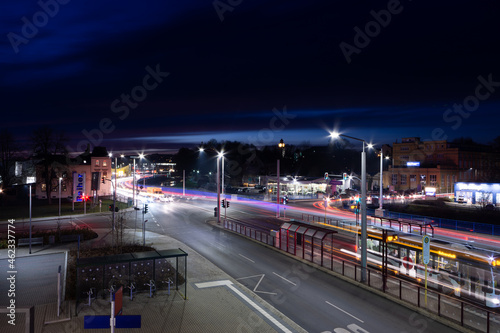 colorful light stripes of cars on the street at night in front of a church in the city of plauen