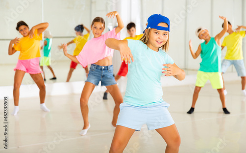 Group of active children dancing hip-hop dance in studio.