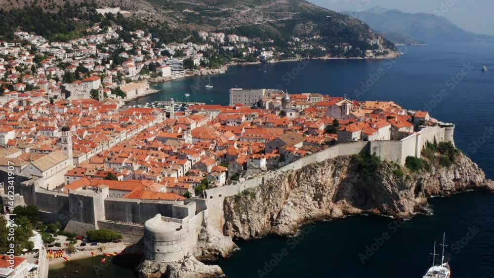 Dubrovnik City And Old Town With Defensive Stone Walls On A Sunny Day In Croatia. - aerial Dubrovnik City And Old Town With Defensive Stone Walls On A Sunny Day In Croatia. - aerial