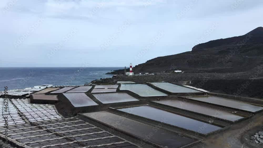Drone aerial view of Salinas de Fuencaliente on the Canary island of La Palma with a lighthouse on a cloudy day Drone aerial view of Salinas de Fuencaliente on the Canary island of La Palma with a lighthouse on a cloudy day