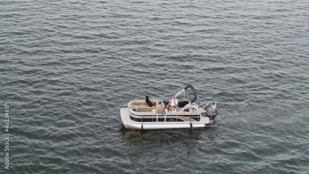 Aerial View Of The Tourists Relaxing In The Pontoon Boat At Lake Pontchartrain In New Orleans, US. Aerial View Of The Tourists Relaxing In The Pontoon Boat At Lake Pontchartrain In New Orleans, US.