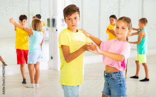 Boys and girls dancing waltz during their group class.