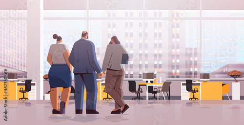 businesspeople team standing back to camera rear view of elegant business people discussing during meeting in office