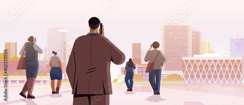 mix race businesspeople team standing back to camera rear view of business people group talking on phone