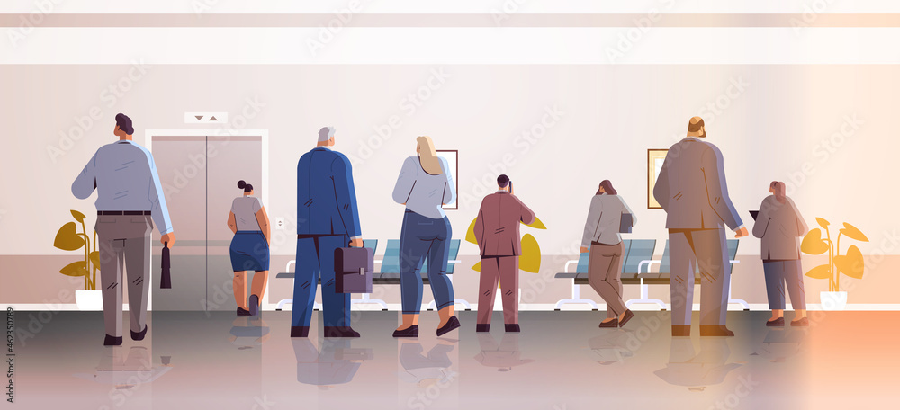 Obraz premium businesspeople standing back to camera rear view of business people group in office corridor