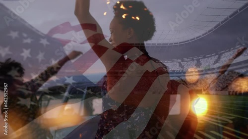 Animation of waving flag of usa over group of friends having fun on the beach and stadium photo