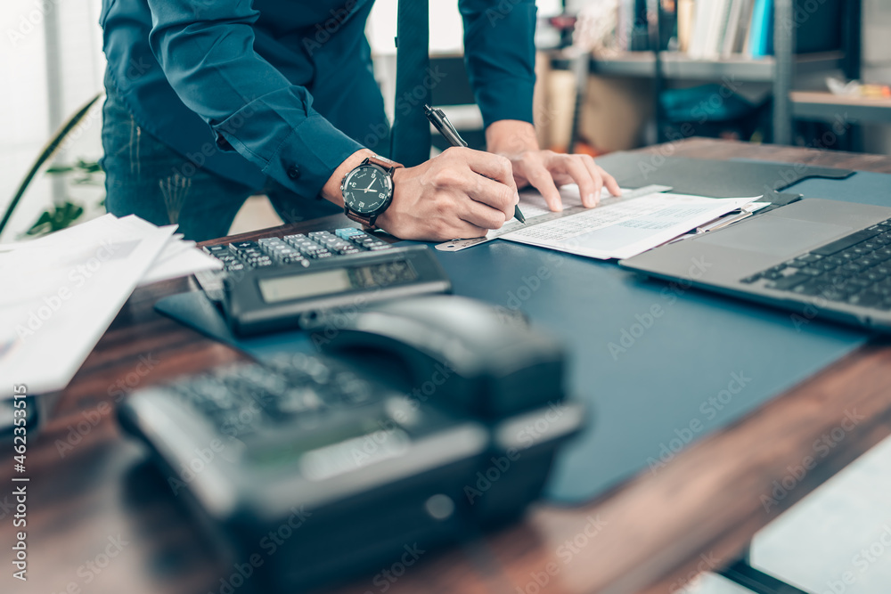 Businessman working on office desk and analyzing new project of accounting finance. Investment, Financial advisor and accounting concept.
