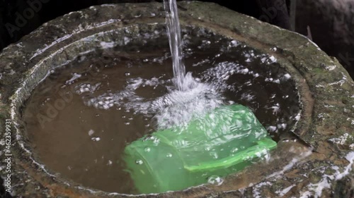 Wallpaper Mural jet of water falling into a pool in which a green plastic jug is floating Torontodigital.ca