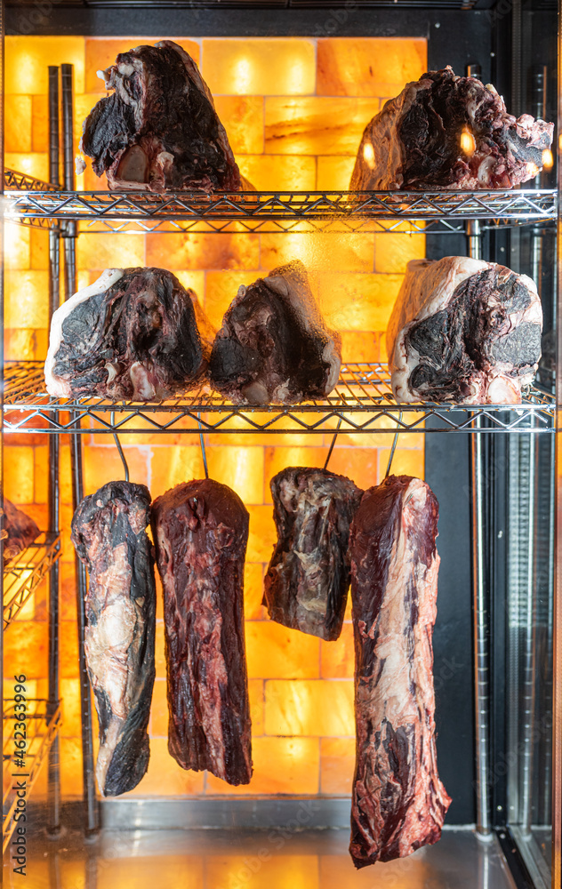 Beef hung and lined up in a dry aged beef cabinet Stock Photo | Adobe Stock