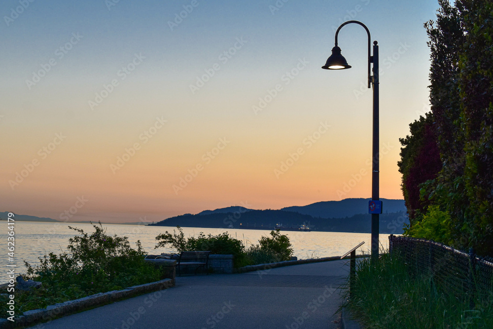 Beautiful sunset - sea, street light and mountain 