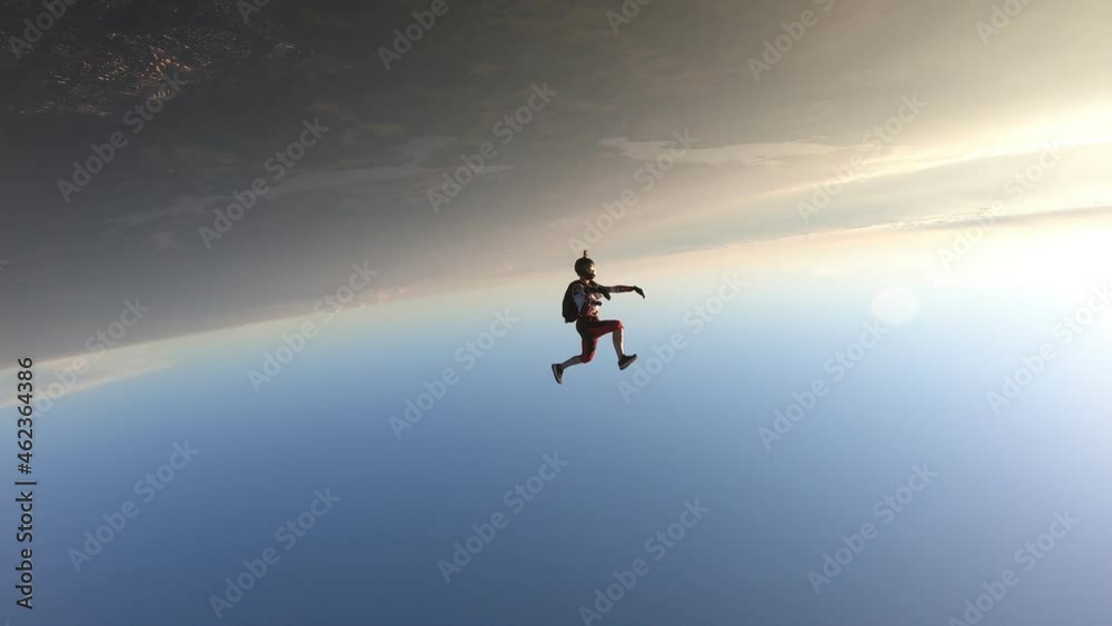 Freefly skydiving. Headdown jump. A happy girl is having fun in the sky. Sunset time. Freefly skydiving. Headdown jump. A happy girl is having fun in the sky. Sunset time.