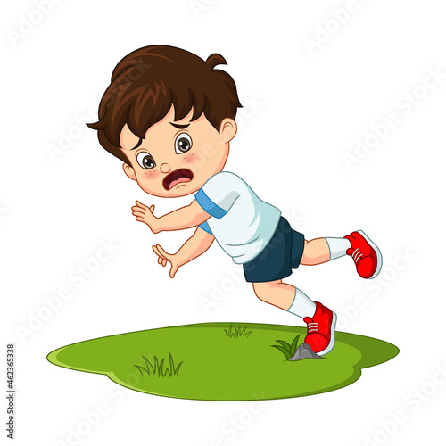 Cute little boy falling down in the grass