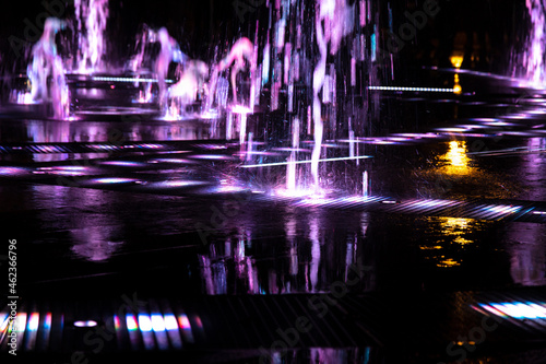 Pink jets of the fountain at night.
