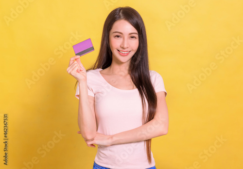beautiful Asian woman  showing credit card for making payment or paying online