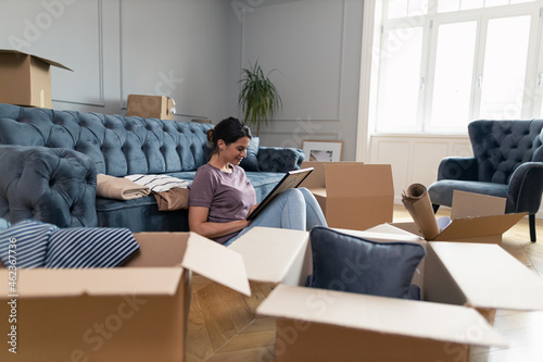 Relaxed woman enjoying in her memories before moving out of the apartment.