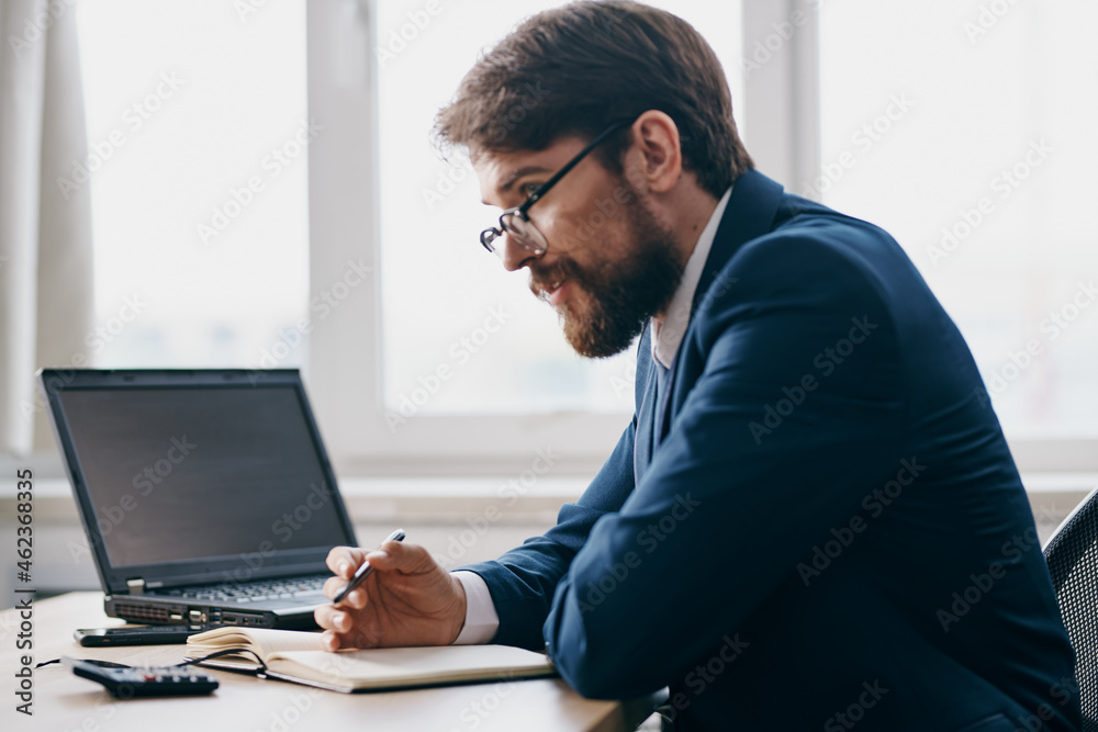 bearded man sitting at a desk in front of a laptop stress anger professional bearded man sitting at a desk in front of a laptop stress anger professional