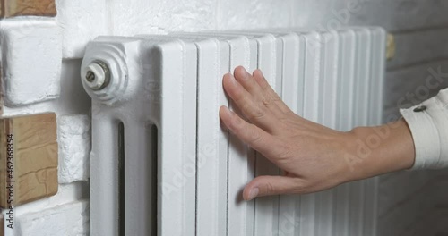 Wallpaper Mural Touch heating system. A woman touch her heating system in the flat during warming season. Torontodigital.ca